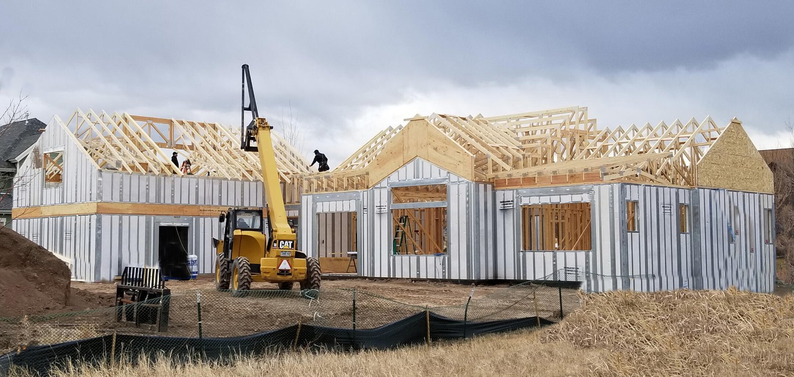 Framers setting ThermaSteel panels with a telehandler